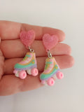 Pendientes patines de cuatro ruedas